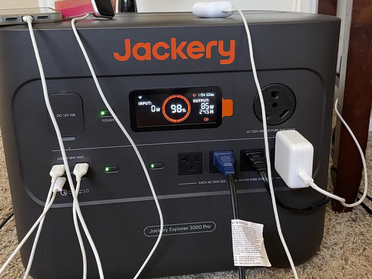 The Jackery 3000 Pro Solar Generator with numerous devices and appliances plugged into it