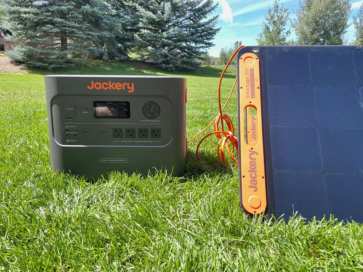 The Jackery 3000 Pro Solar Generator connected to its solar panels to charge in a sunny yard