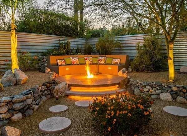 Backyard with corrugated metal fence and circular firepit