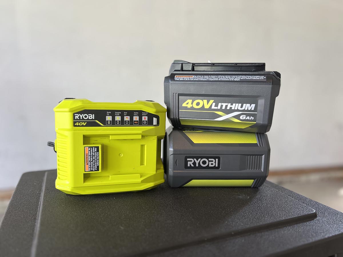 The batteries and charger of the Ryobi 21-inch self-propelled all-wheel-drive mower