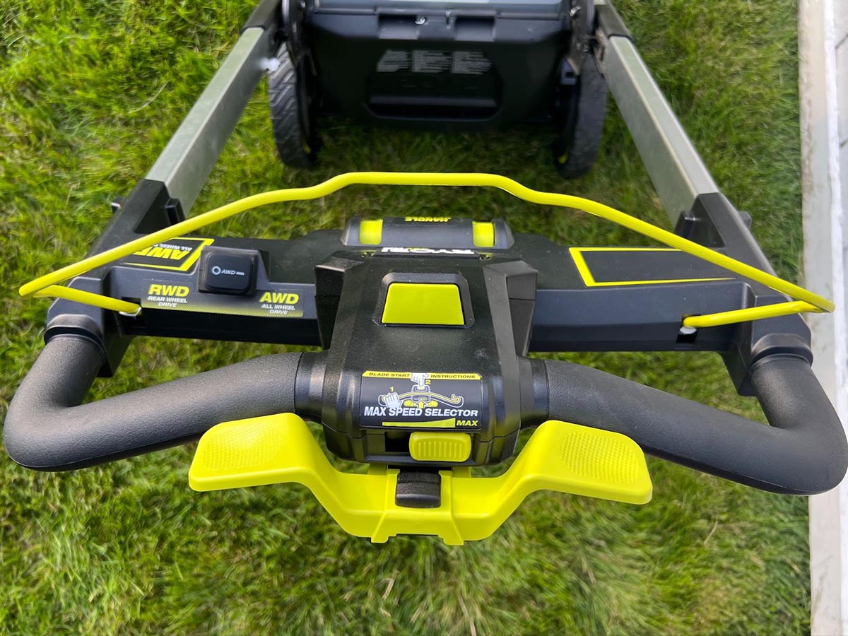 A closeup of the handle and controls of the Ryobi 21-inch self-propelled all-wheel-drive mower