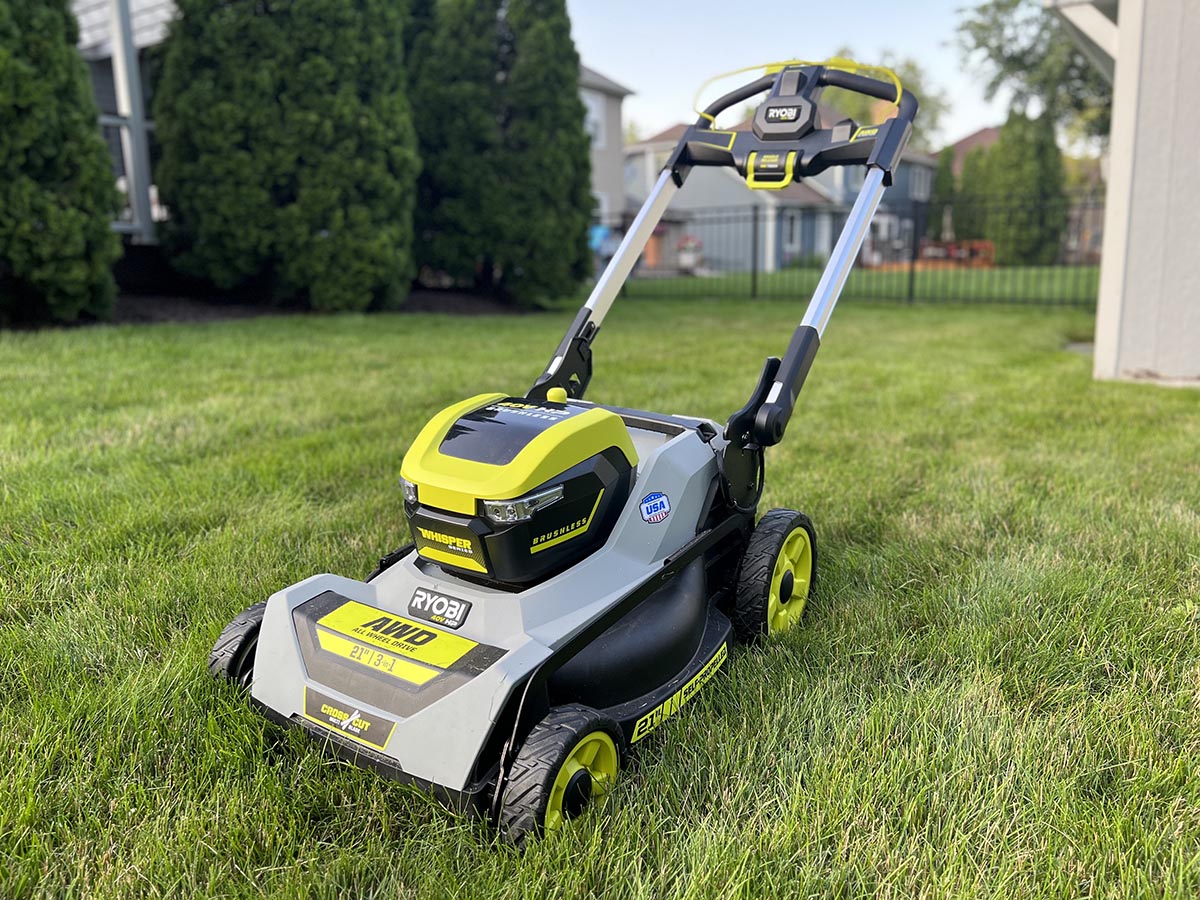 The Ryobi 21-inch self-propelled all-wheel-drive mower on a neatly trimmed lawn