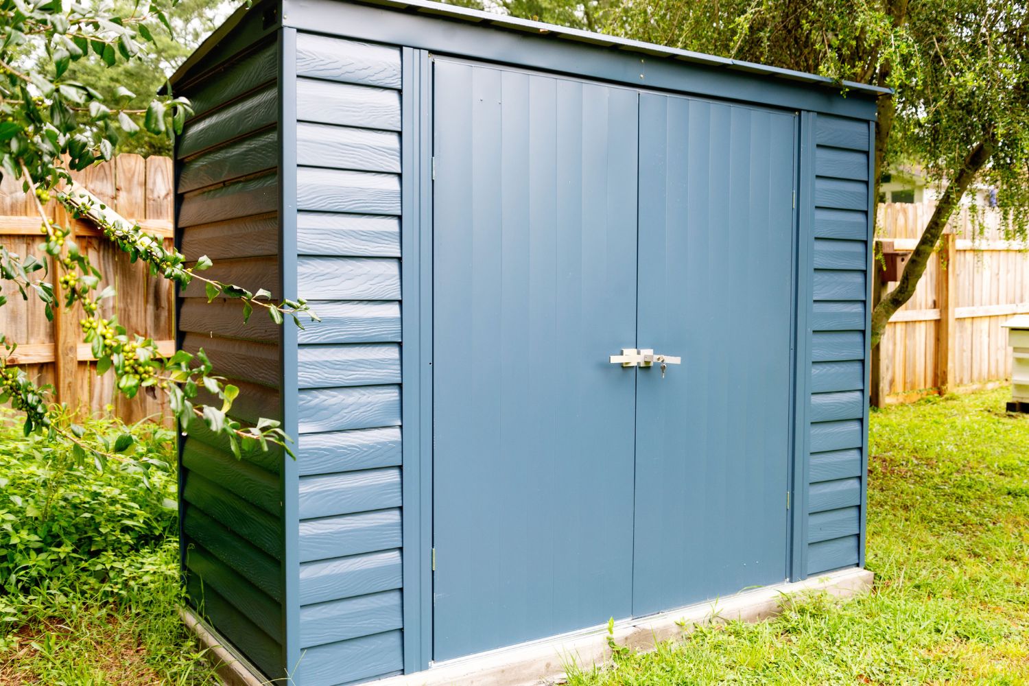 A angled view of the ShelterLogic storage shed in a backyard