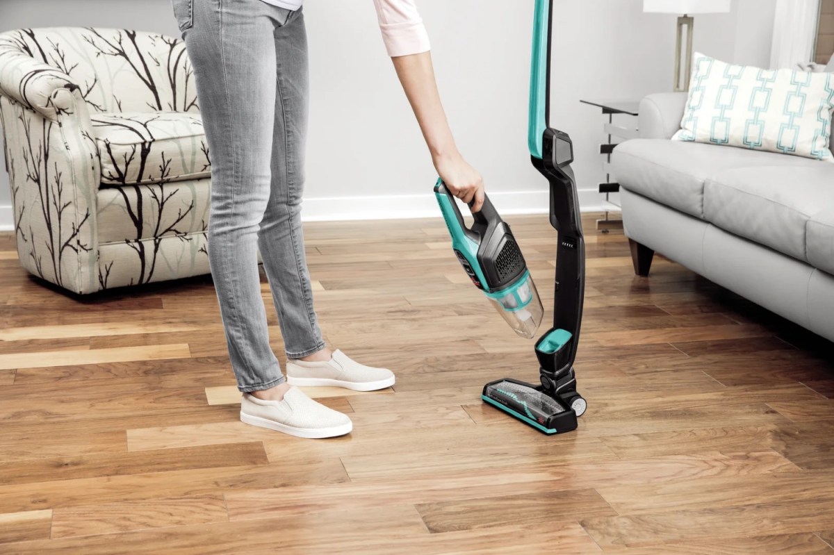A person removing the handheld portion of the best cordless vacuum for hardwood floors option