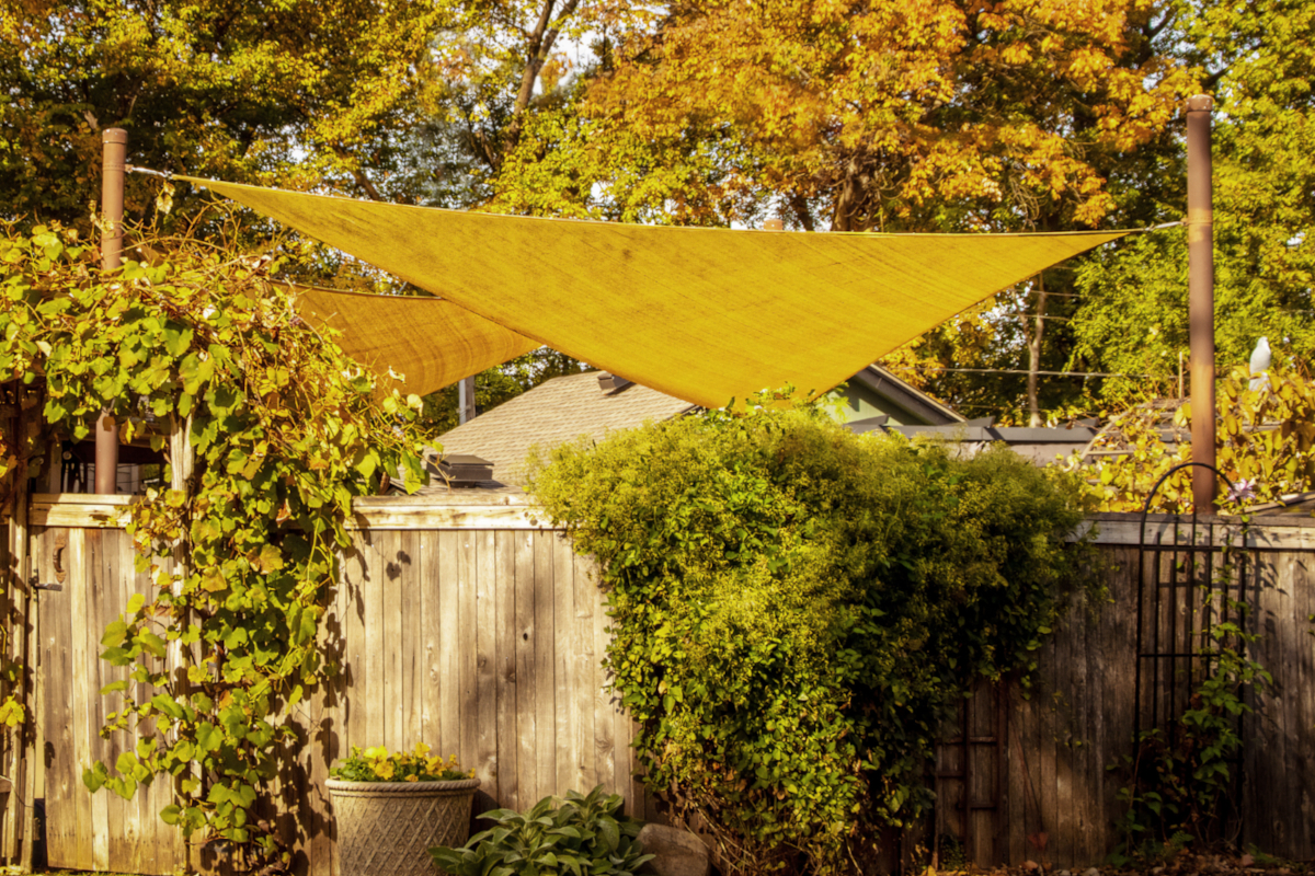 Triangular shade sail in a verdant backyard