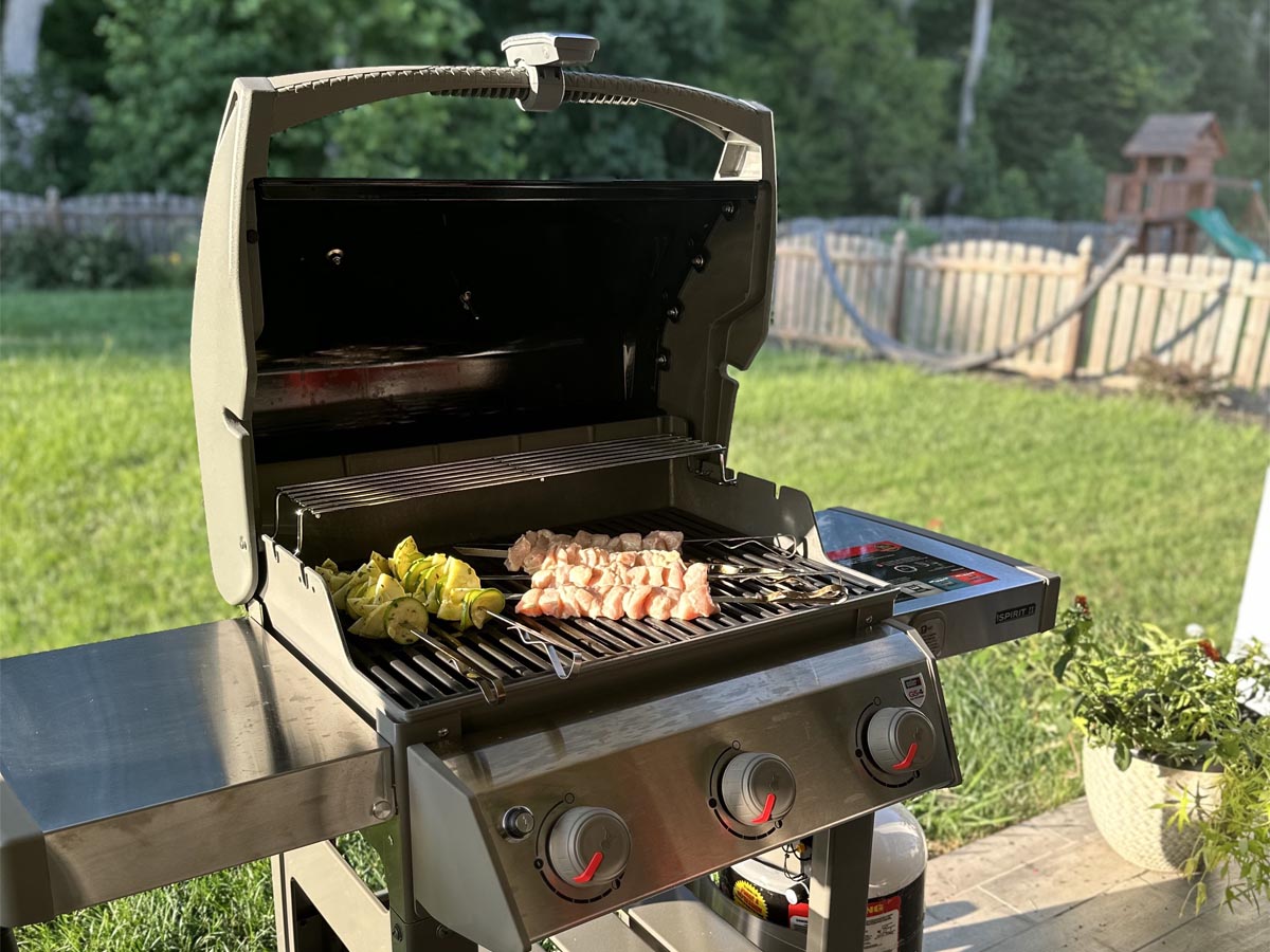 Meat and veggies cooking on the Weber Spirit II E-310 Gas Grill