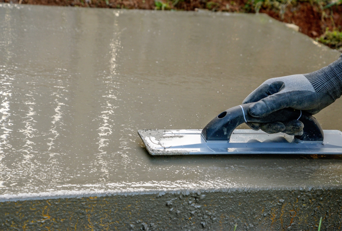 Using trowel to smooth concrete slab