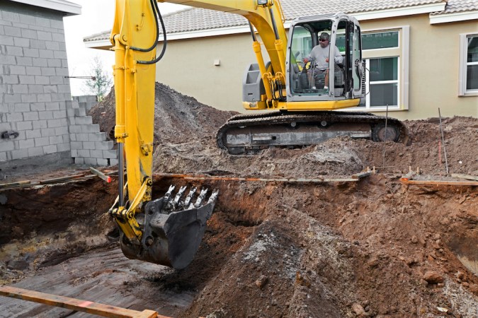 Backhoe digging for a residential swimming pool