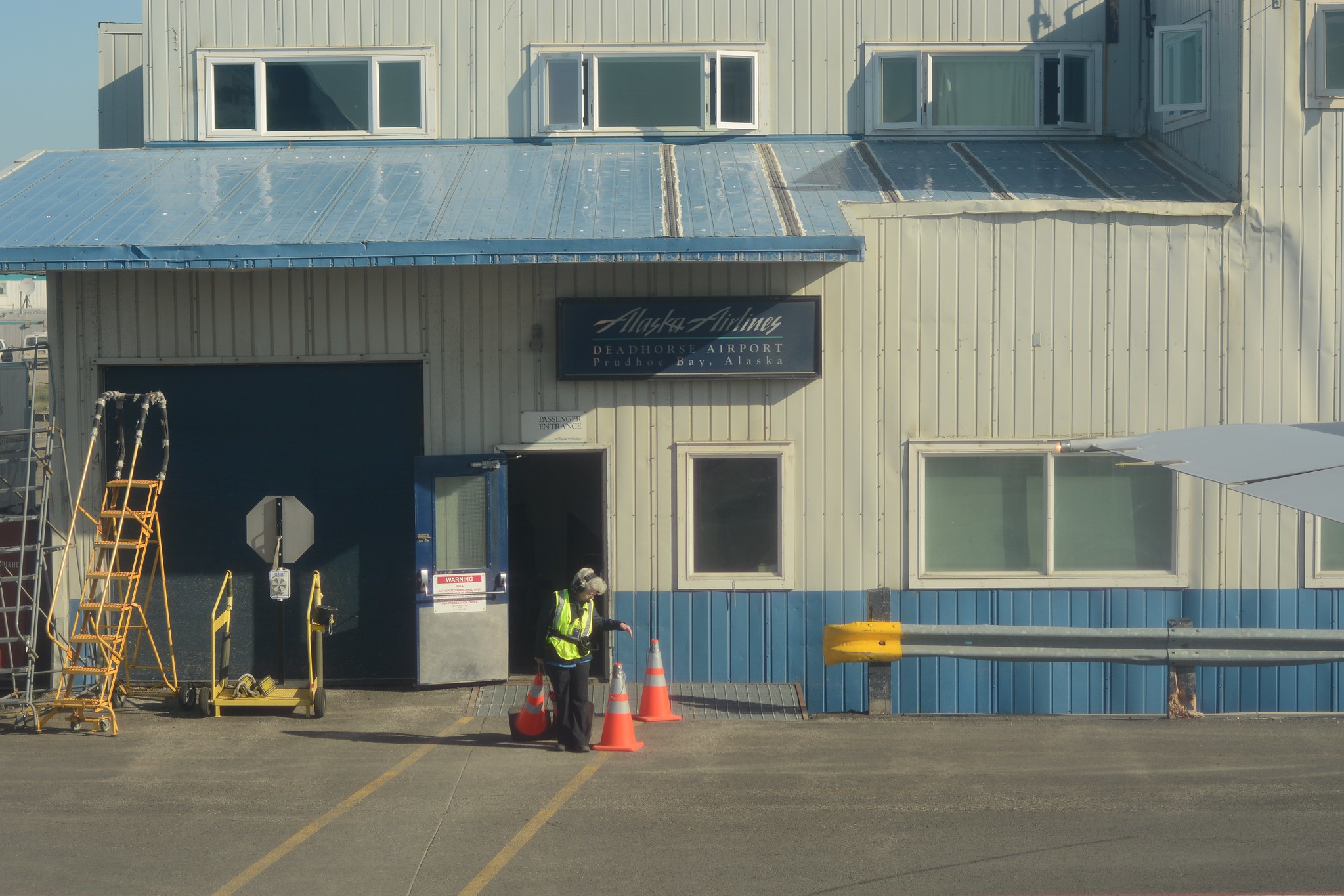 woman airport worker standing outside of deadhorse airport in alaska