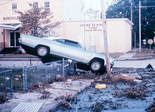 Car on a fence from hurricane Camille