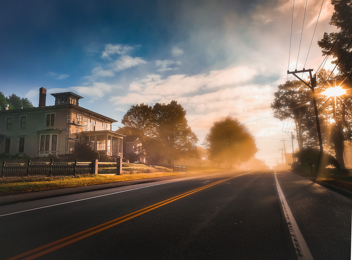 small town residential road with morning fog