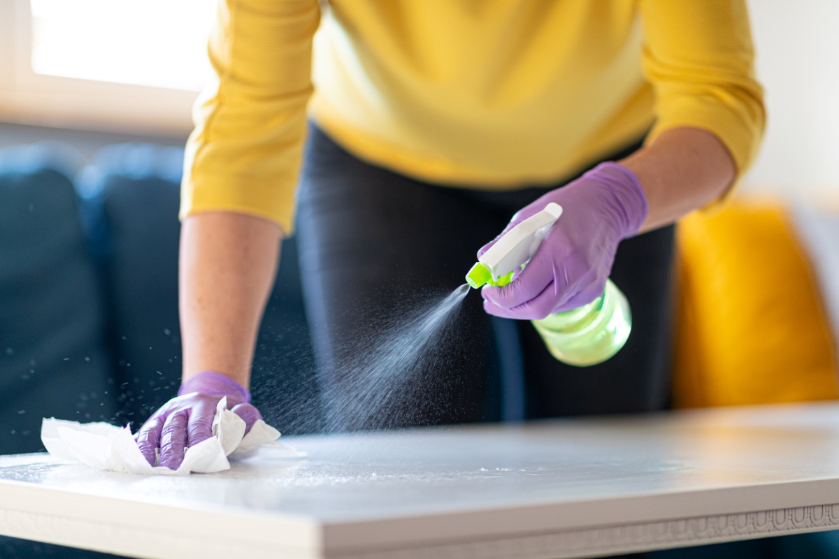 person cleaning table top
