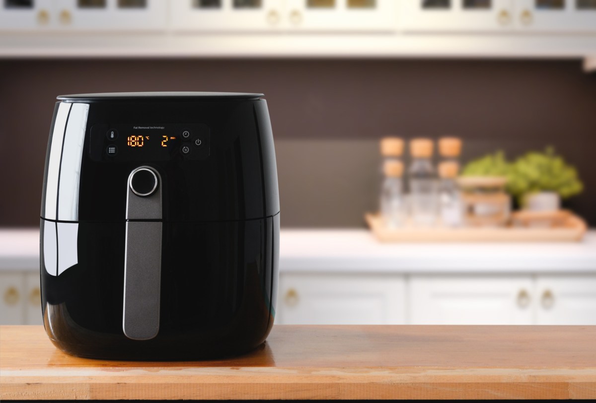 a black shiny air fryer on a kitchen counter