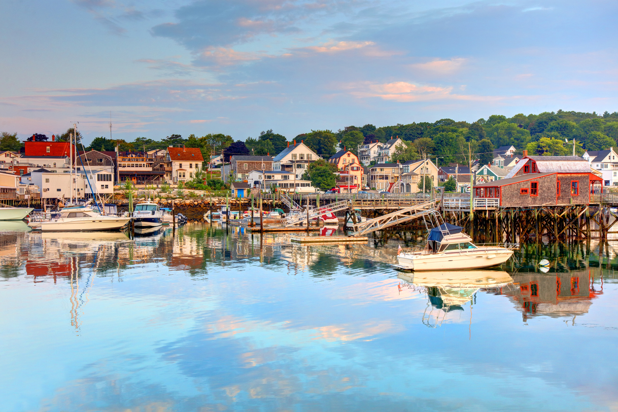 harbor in Maine with boats docked and small houses lining the water