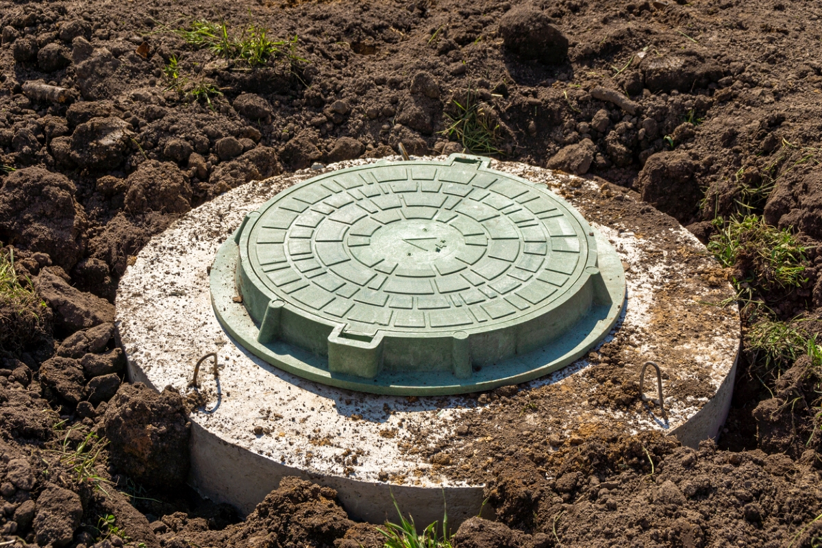 Septic tank lid covered with dirt