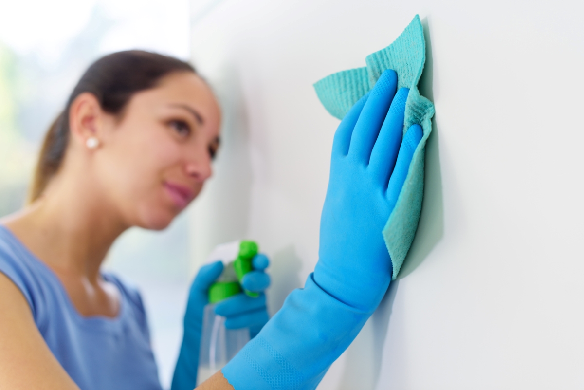 woman cleaning wall