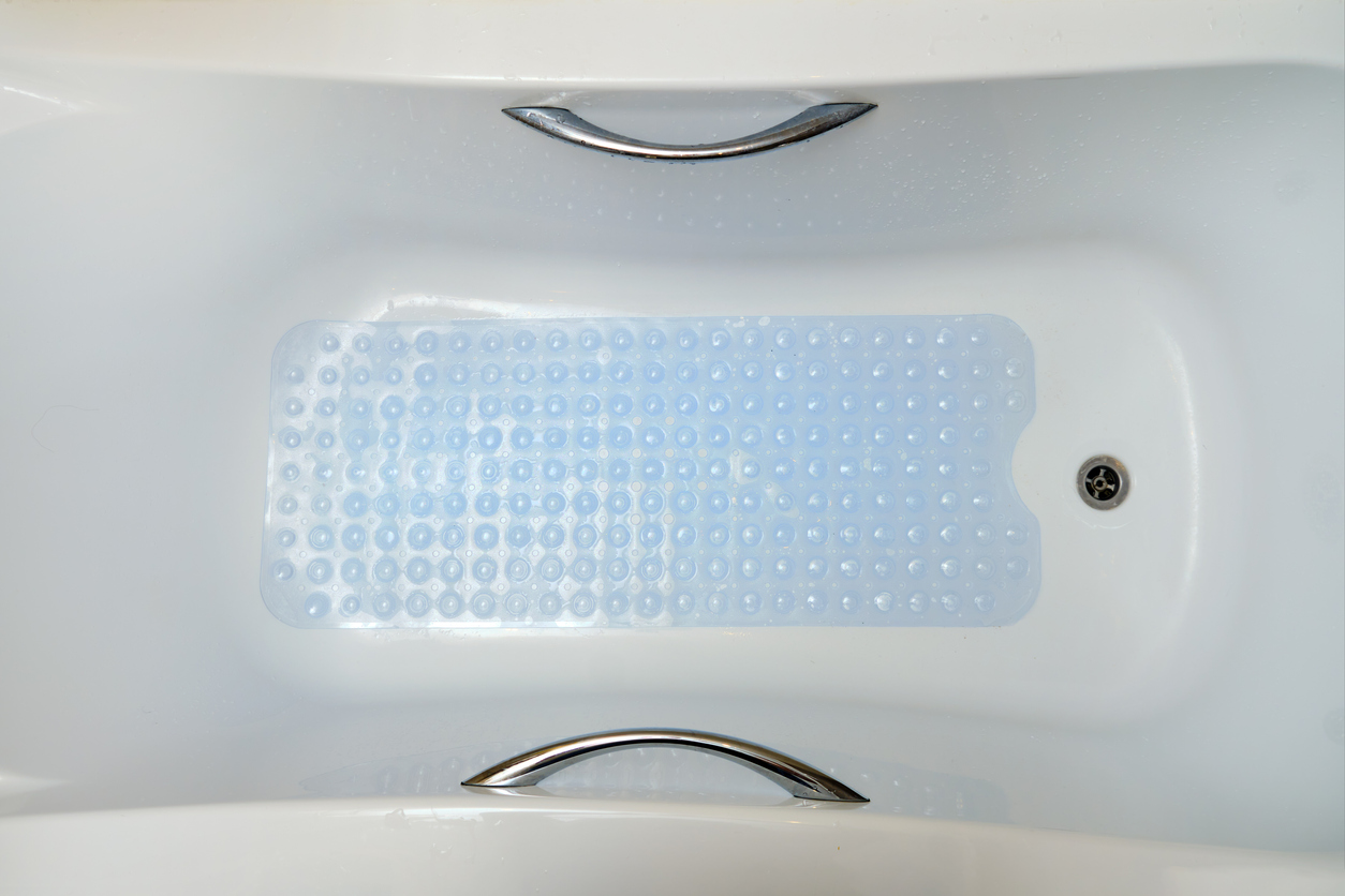 overhead view of tub with blue non-slip liner