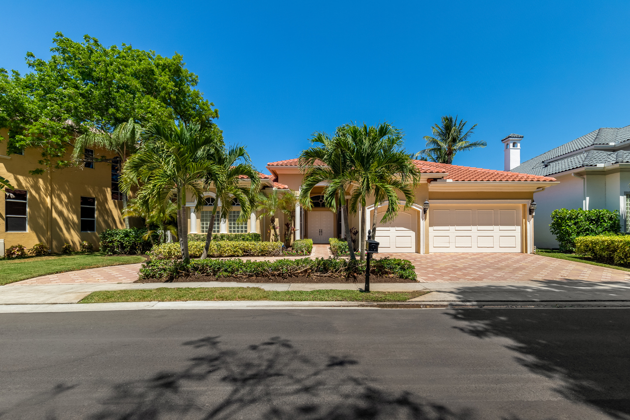 house with palm trees on lawn in boca raton Florida