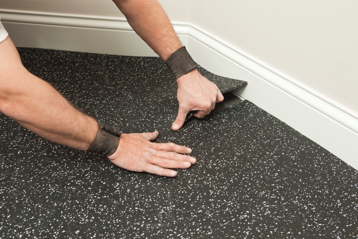 Person installing rubber flooring