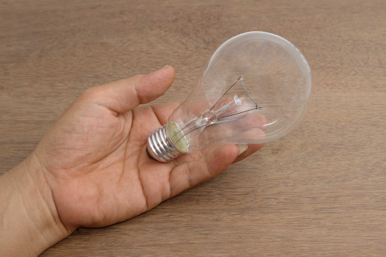 incandescent light bulb in hand