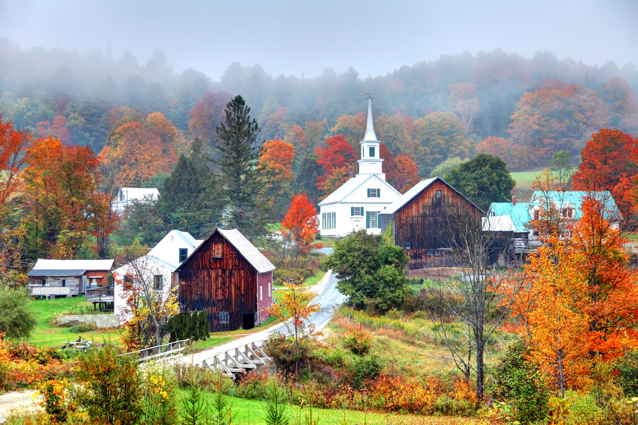 Autumn in small rural Vermont town with orange trees and old wood buildings