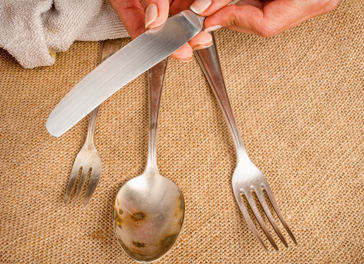 Person polishing silver utensils