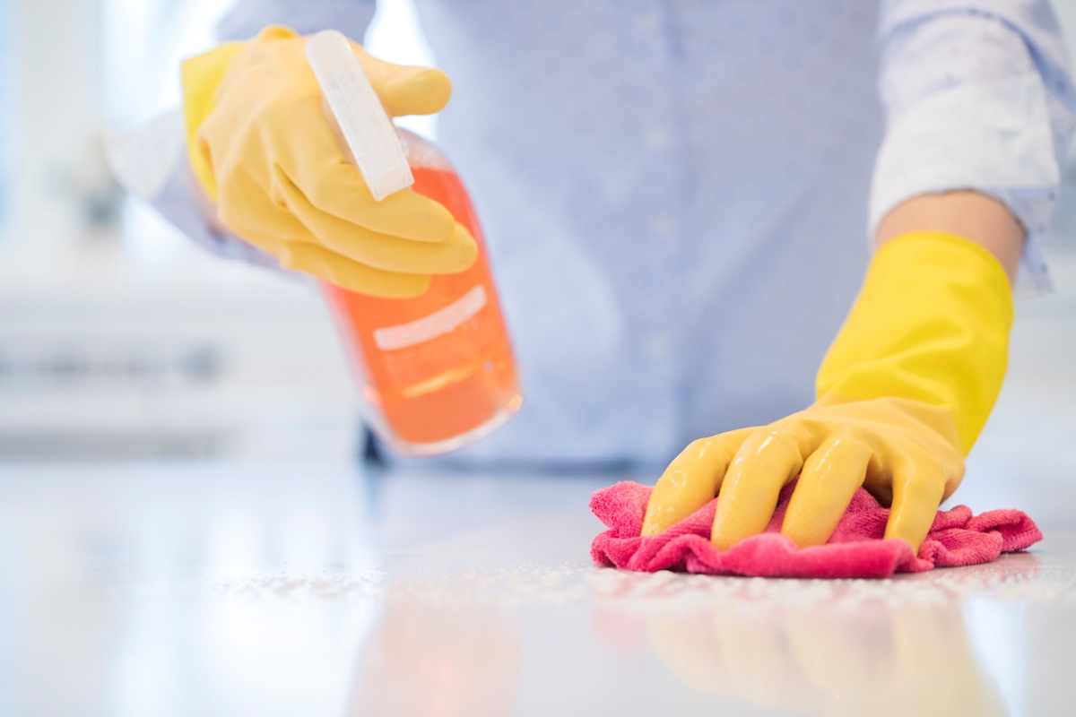 Cleaning countertop with orange spray