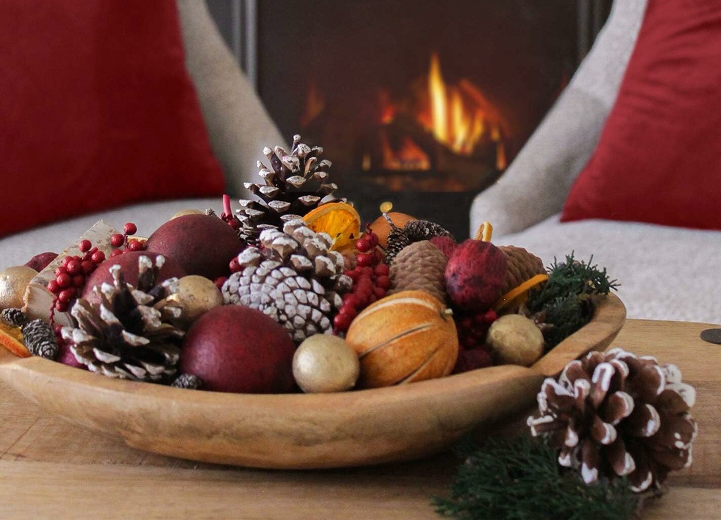 Winter potpourri on table with fireplace in background
