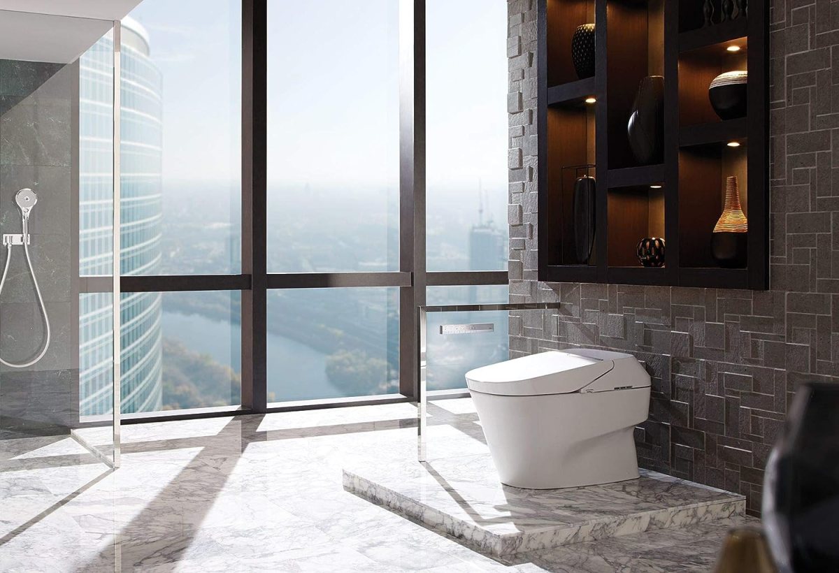 The best smart toilets option installed in a spacious bathroom that has large windows overlooking a river running through a city