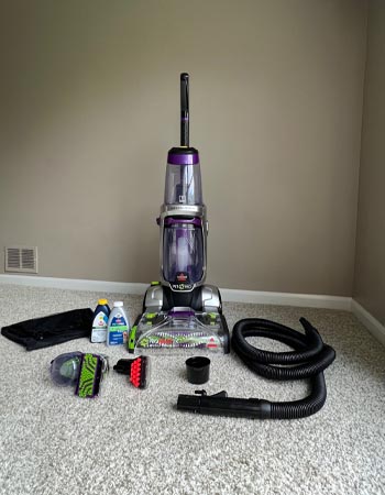 New Bissell ProHeat 2X Revolution Pet Pro carpet cleaner with included accessories and cleaning solution.