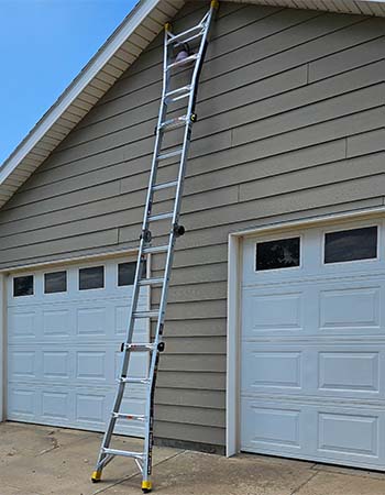 The Gorilla GLMPXA-22 ladder set up as an extension ladder reaching up to a roof