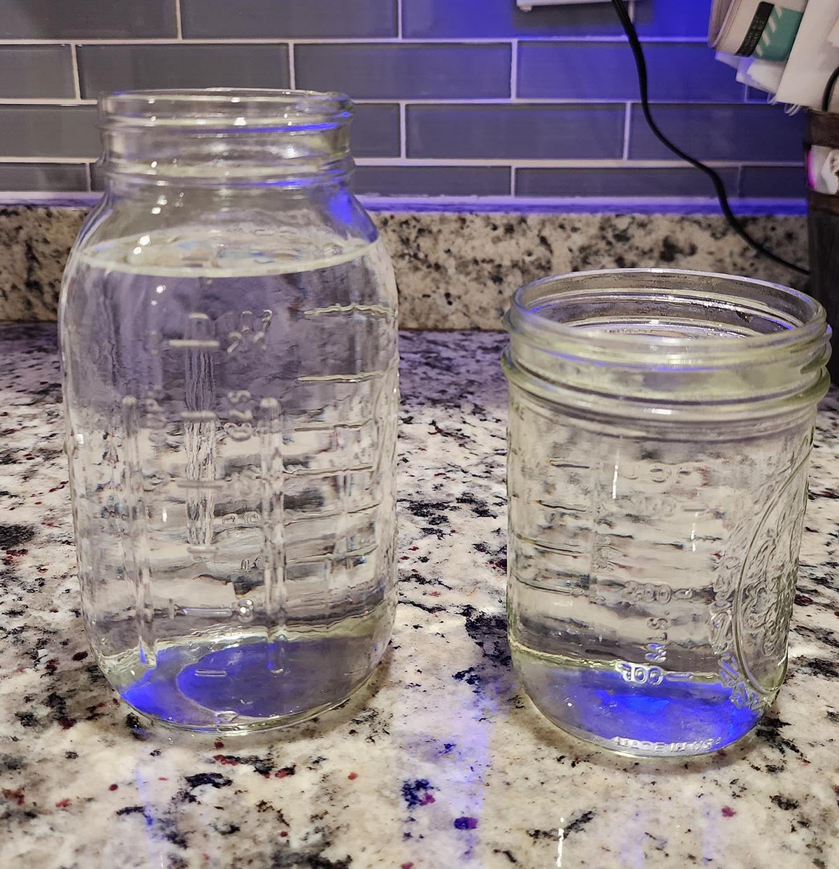 Two full mason jars of water collected using the Hisense wi-fi dehumidifier