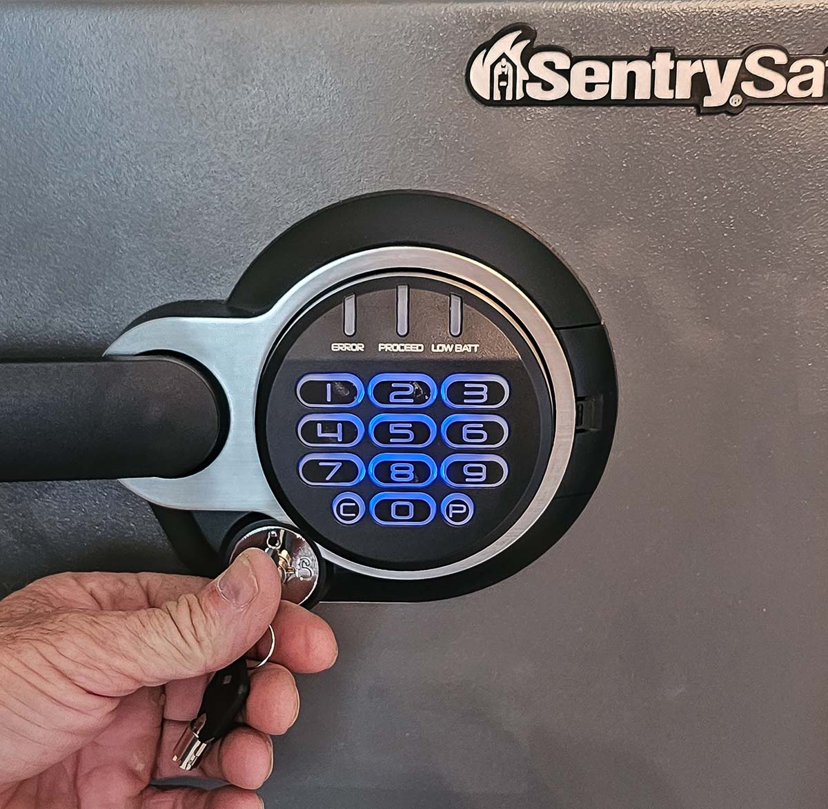 A person using a key on the keypad of the SentrySafe SFW123GDC