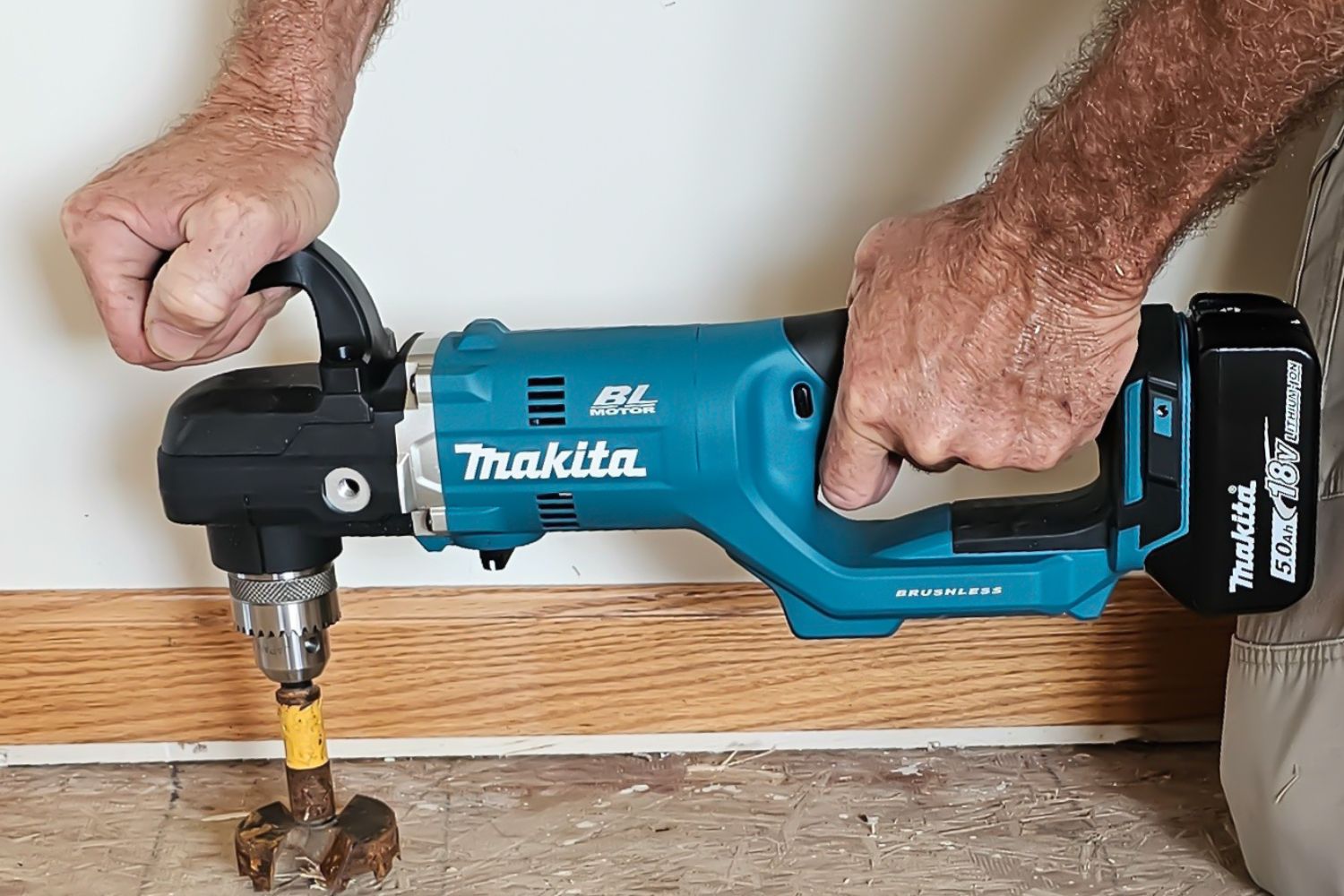 A person actively using the Makita right-angle drill