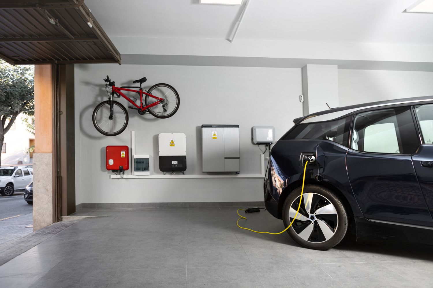 An EV is charging inside a garage.