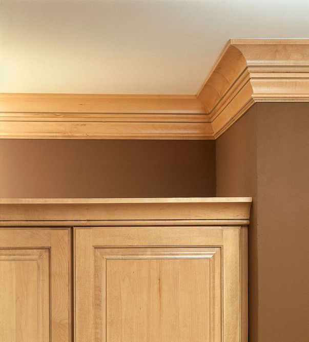 Light brown cove molding above matching cabinet