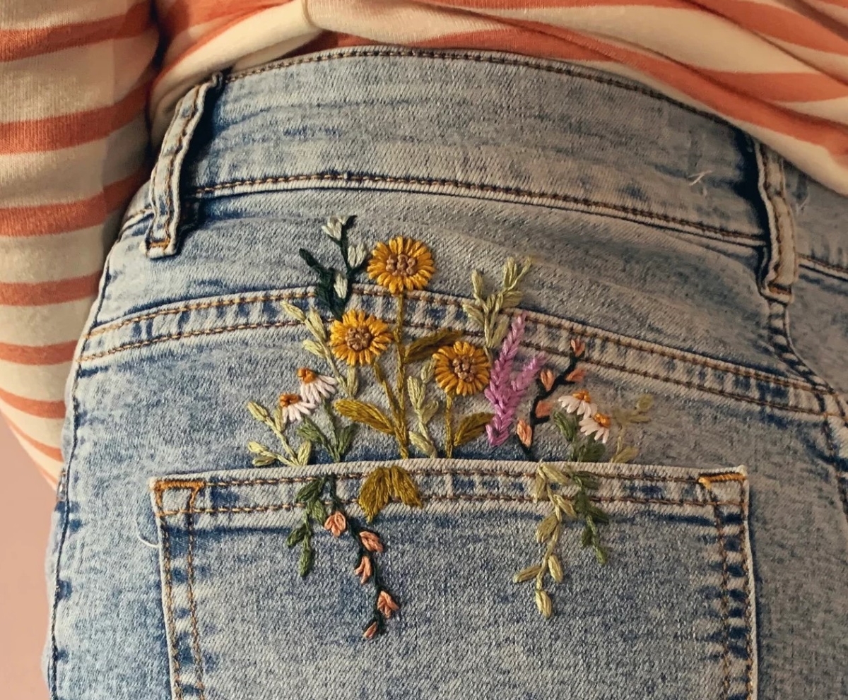 Embroidered flowers on jean pocket