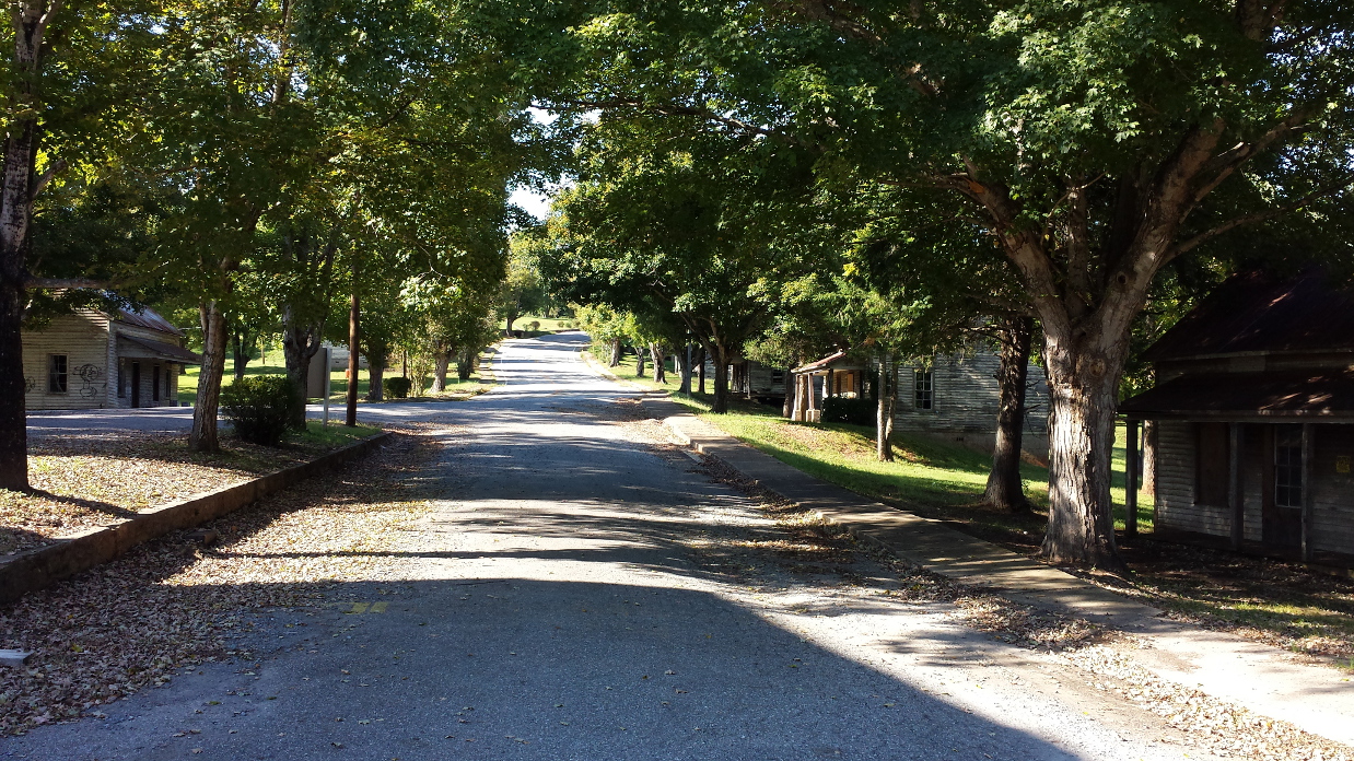 view up the road of abandoned mill town in north carolina