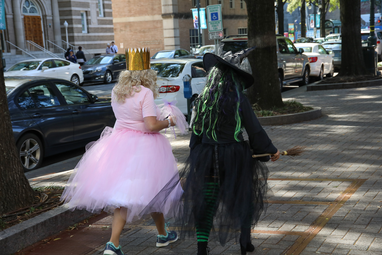 Charlotte, NC, USA-10/31/18: Two women dressed for Halloween as good and evil witches.