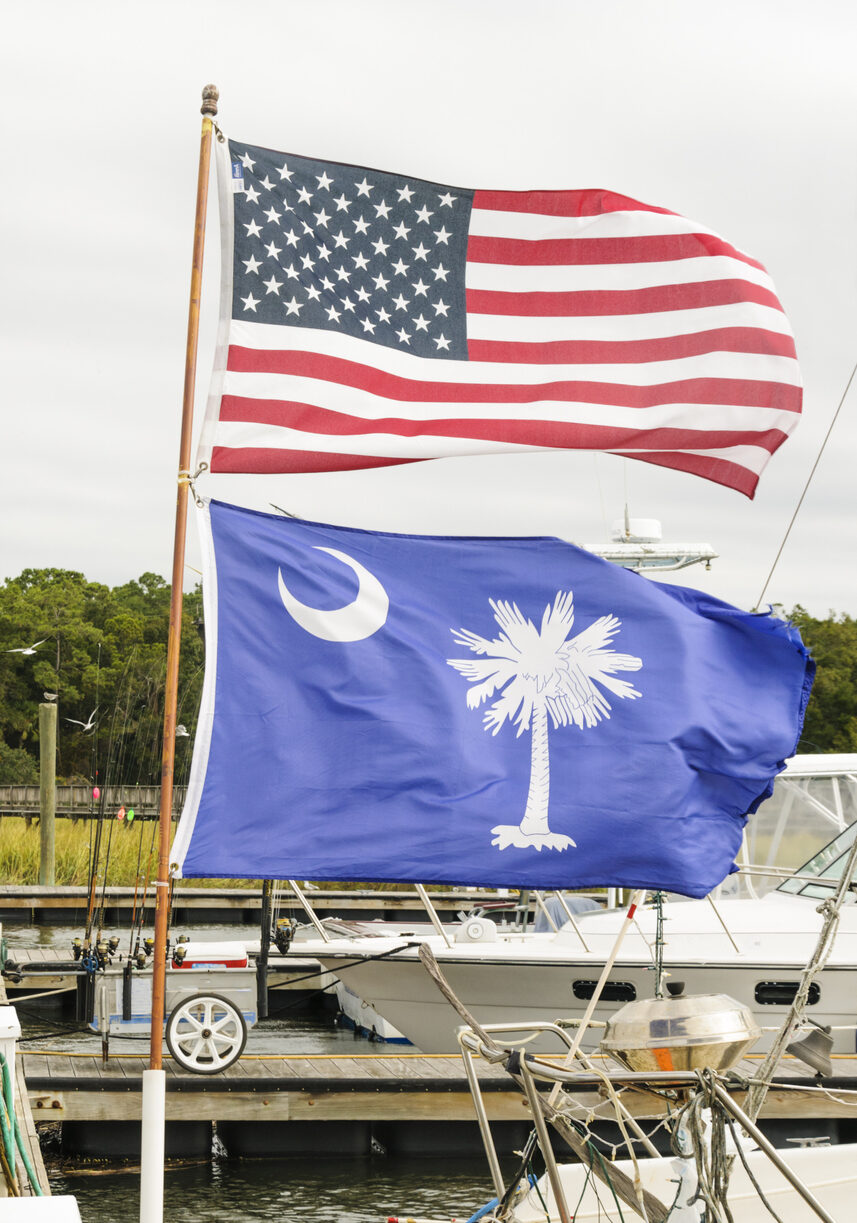 American Flag and South Carolina state flag fly at a dock