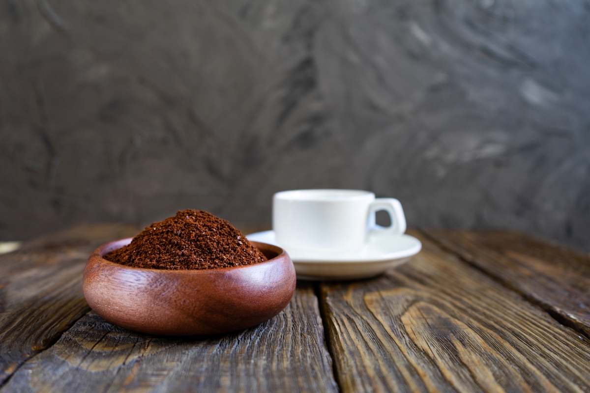 Coffee grounds in wooden bowl