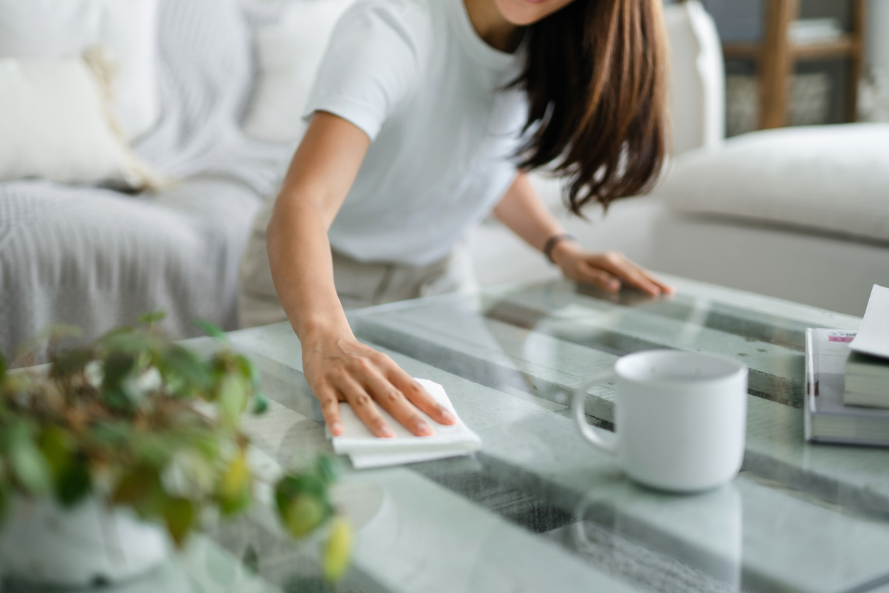 woman dusting coffee table