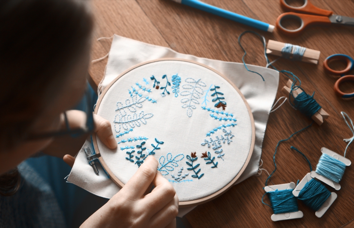 Woman embroidering pattern