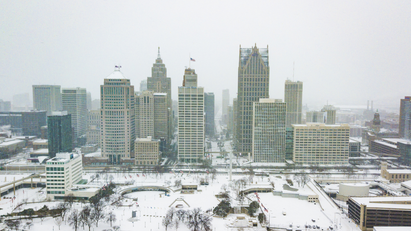 An aerial view of the city skyline of Detroit, Michigan on Christmas Day 2020 while it snows.