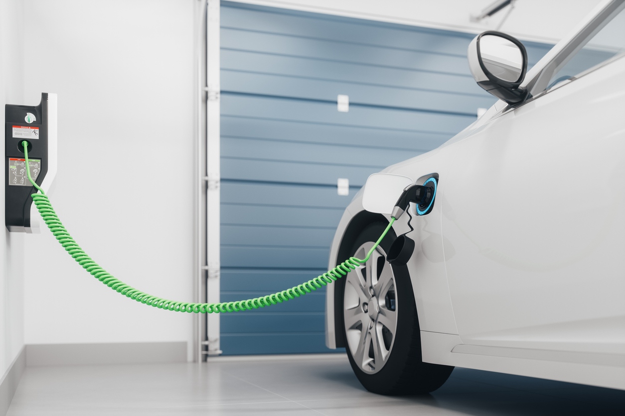 electric-car-plugged-into-a-home-charger-in-a-garage