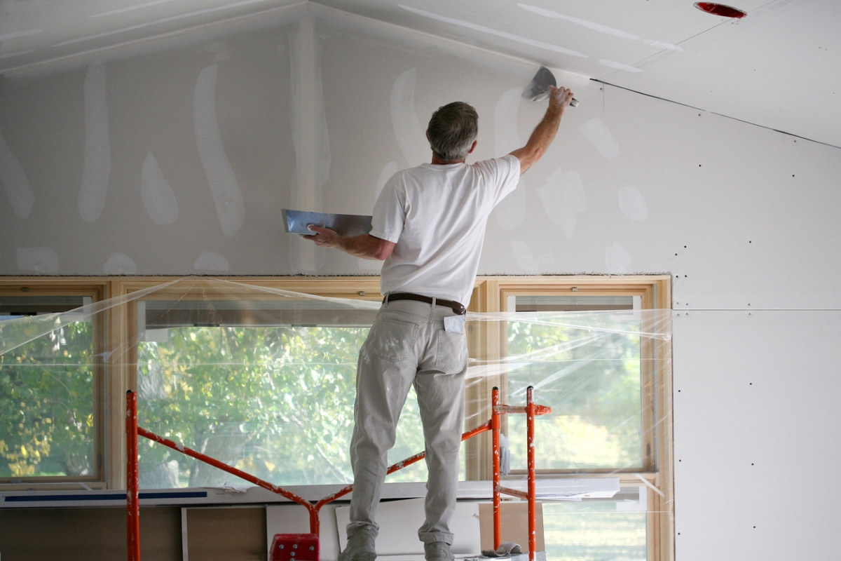 Person painting drywall