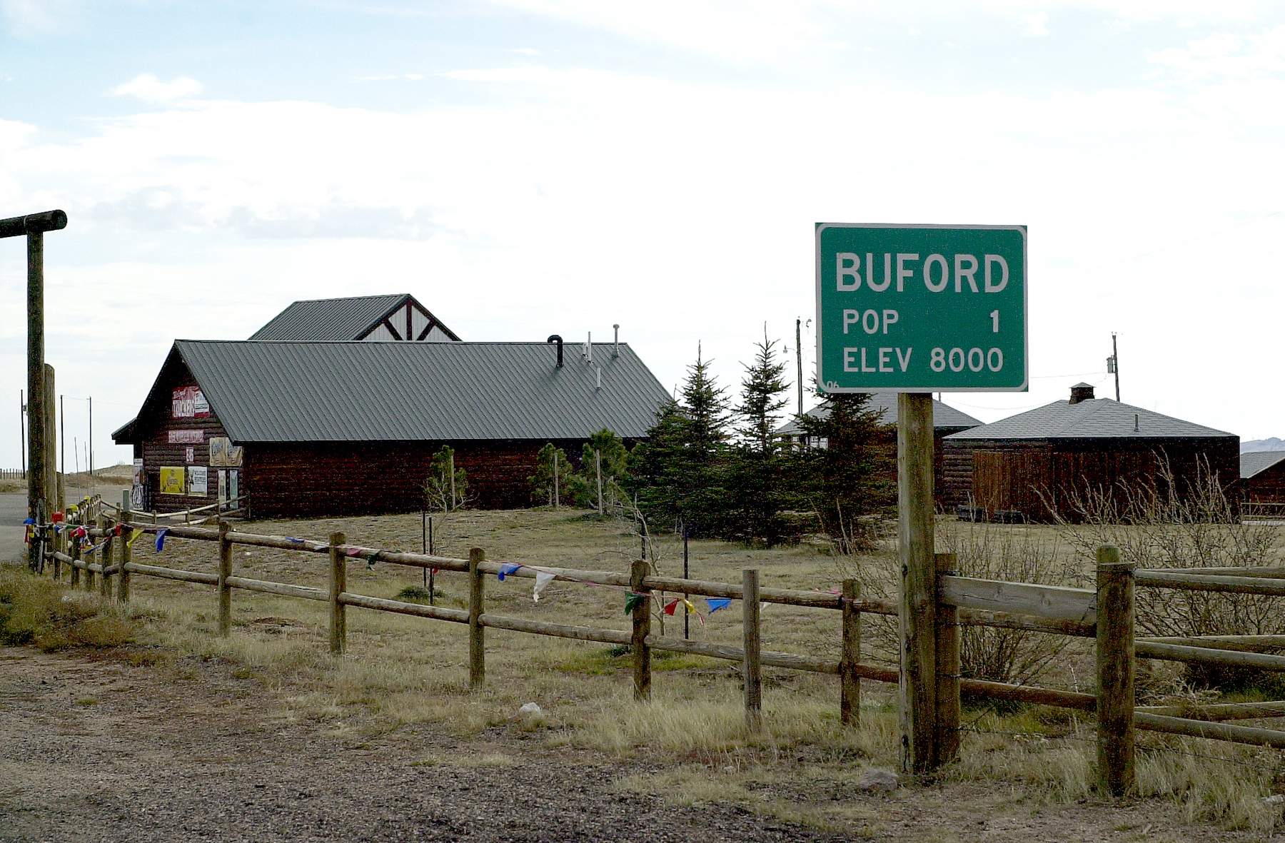road sign for buford wyoming in front of farm house