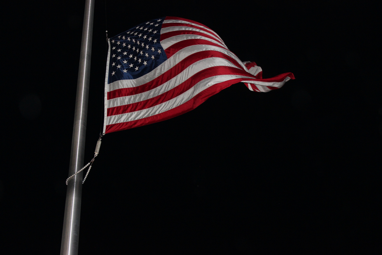 American Flag flying against a black night sky
