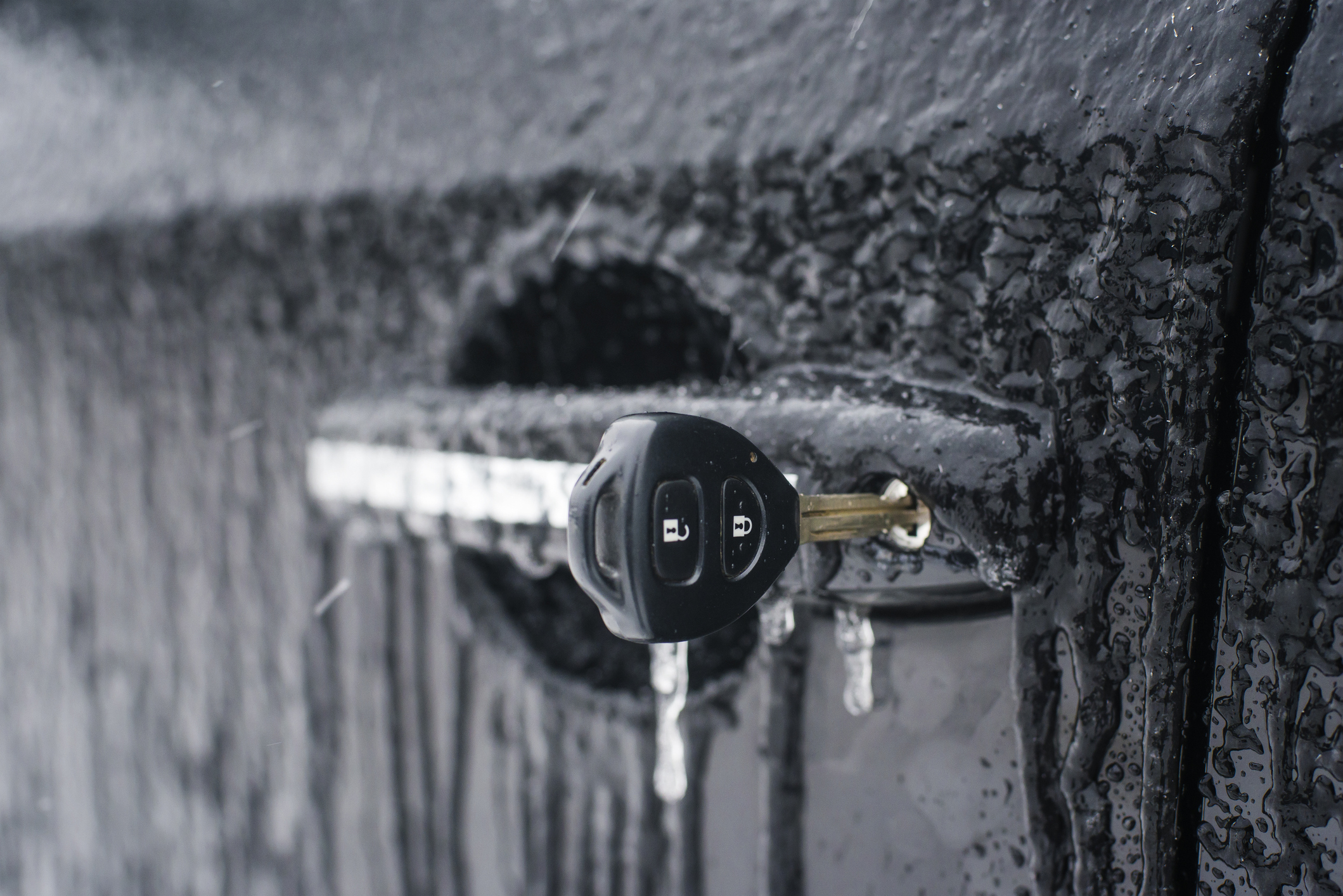 key inserted into the vehicle door lock with a shallow depth of field