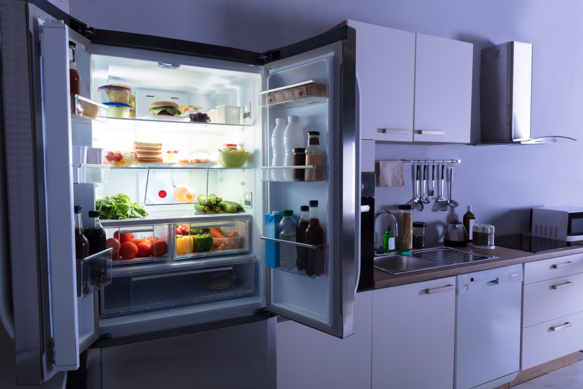 Open fridge in dark kitchen